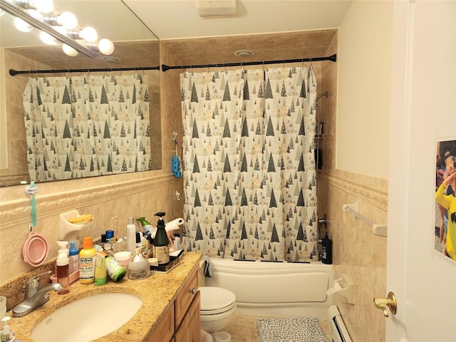 full bathroom with shower / tub combo with curtain, baseboard heating, tile walls, vanity, and toilet