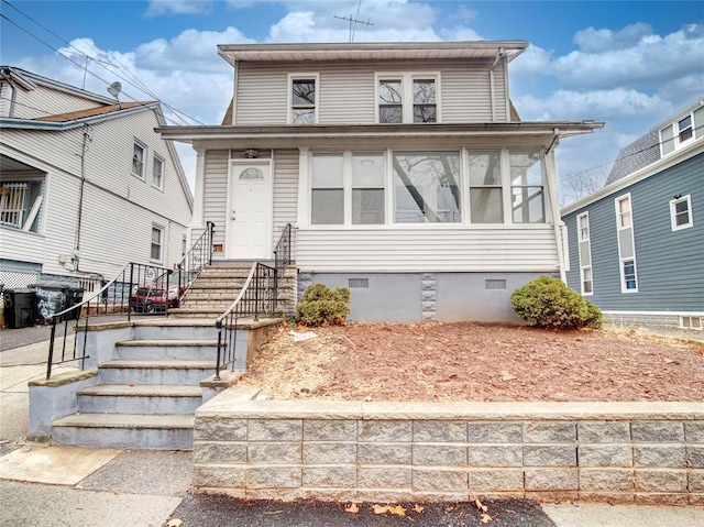 view of front facade with a sunroom