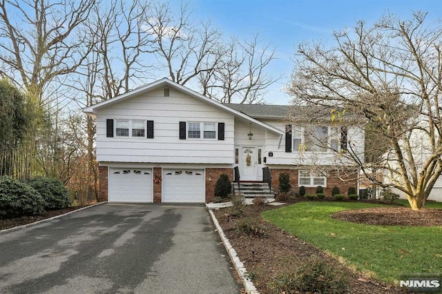 split foyer home with a front yard and a garage