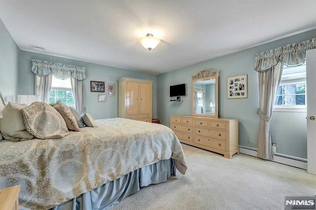 carpeted bedroom featuring a baseboard radiator