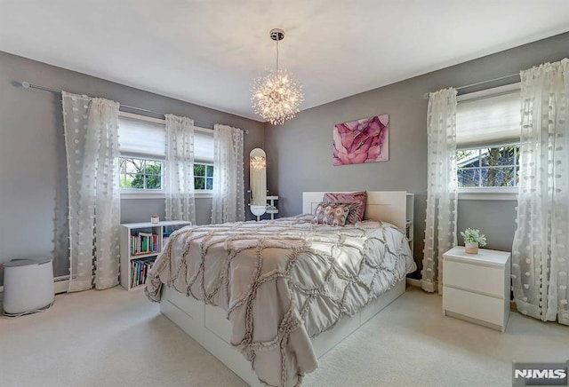 bedroom with an inviting chandelier and light carpet