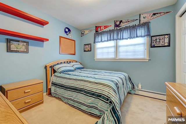 bedroom with a baseboard radiator and carpet flooring