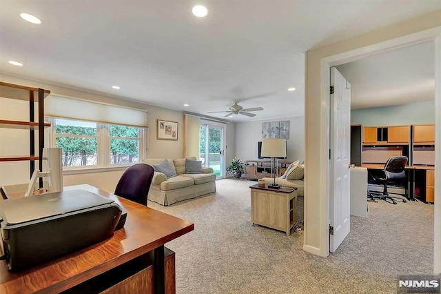 carpeted living room featuring ceiling fan and a baseboard radiator