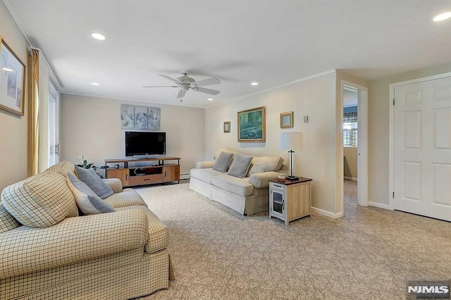 living room featuring ceiling fan, ornamental molding, and light colored carpet