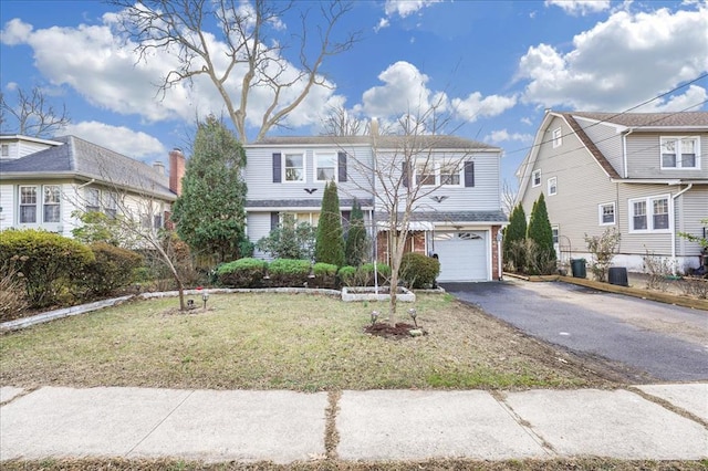 view of front property with a front yard and a garage