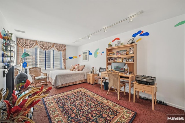 bedroom with carpet and rail lighting