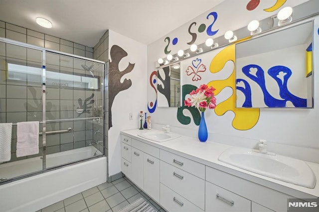 bathroom with shower / bath combination with glass door, vanity, and tile patterned flooring