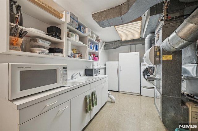 washroom featuring sink and washer / clothes dryer