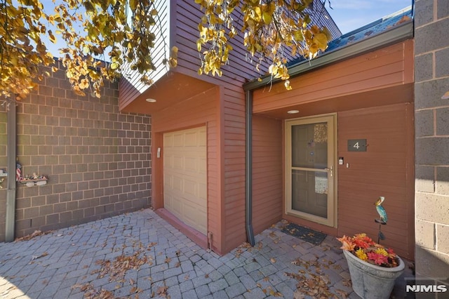 view of exterior entry featuring a garage