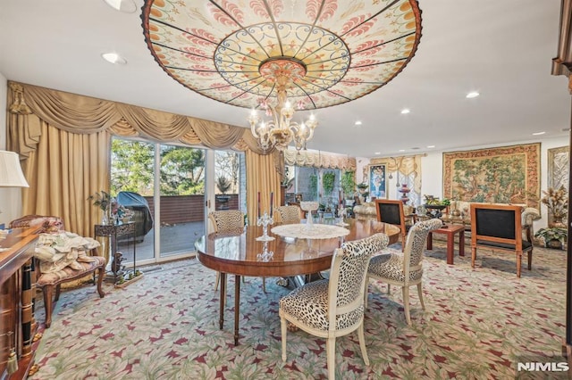 carpeted dining room with an inviting chandelier