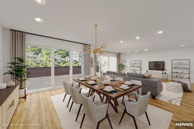 dining room featuring light hardwood / wood-style flooring and a notable chandelier