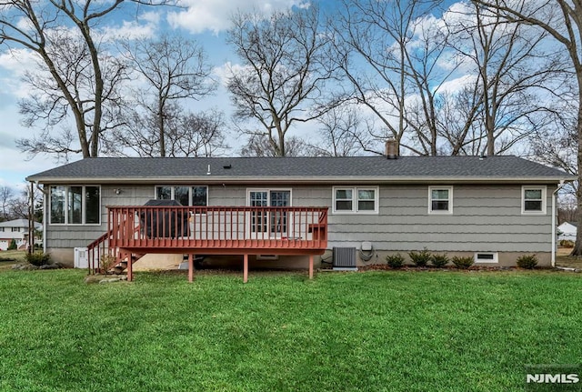 back of house featuring a yard, a wooden deck, and central air condition unit