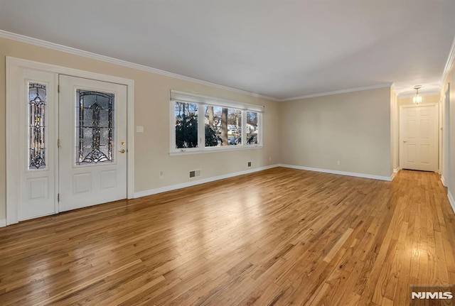 interior space featuring ornamental molding and light wood-type flooring