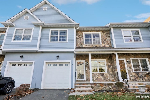 view of property featuring a porch and a garage