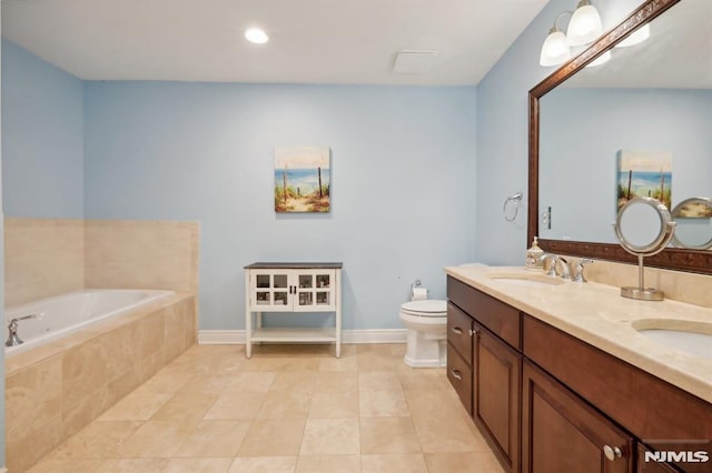 bathroom featuring toilet, tile patterned flooring, vanity, and tiled bath