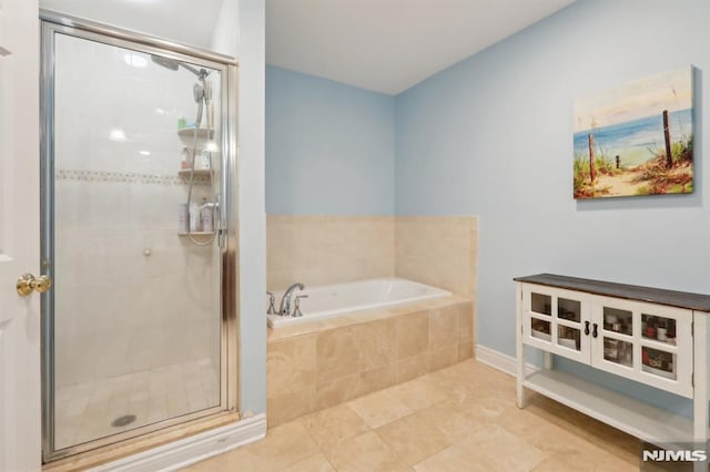 bathroom with tile patterned floors and separate shower and tub