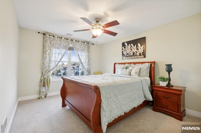 bedroom featuring light carpet and ceiling fan