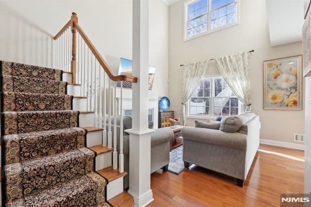 living room featuring a high ceiling and light hardwood / wood-style floors