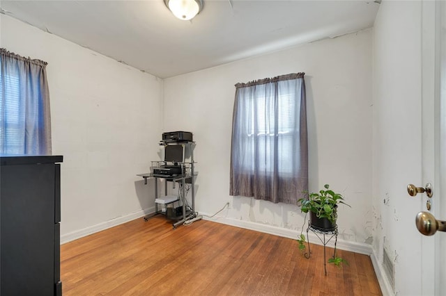 workout area with wood-type flooring