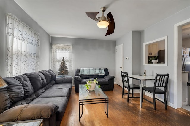 living room featuring wood-type flooring and ceiling fan