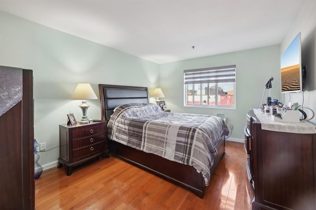 bedroom with hardwood / wood-style floors