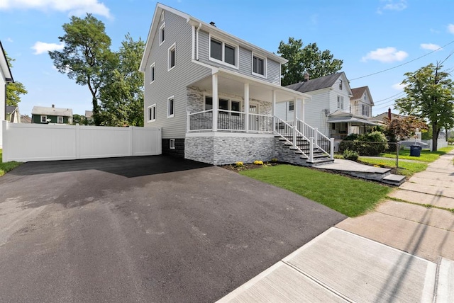 view of front of house featuring covered porch and a front yard