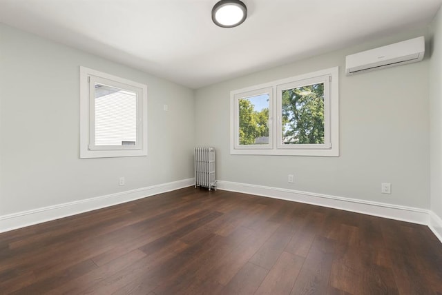 unfurnished room with an AC wall unit, radiator heating unit, and dark hardwood / wood-style floors