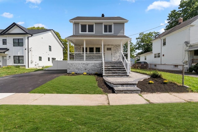 view of front of property with a porch and a front lawn