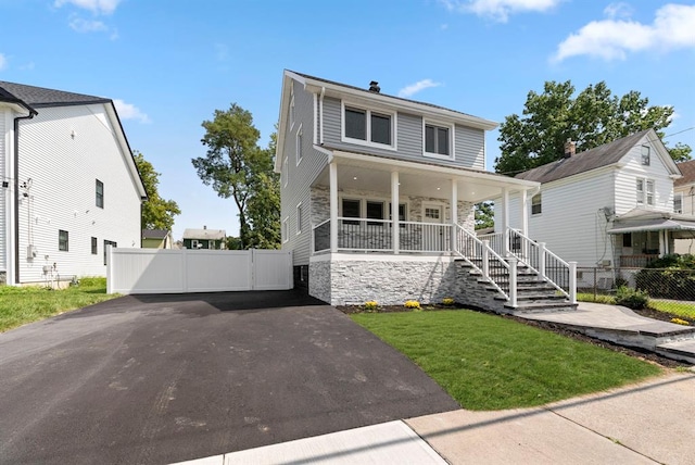 view of front of house with covered porch and a front yard