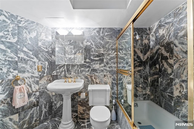 bathroom featuring toilet, tile walls, and bathtub / shower combination