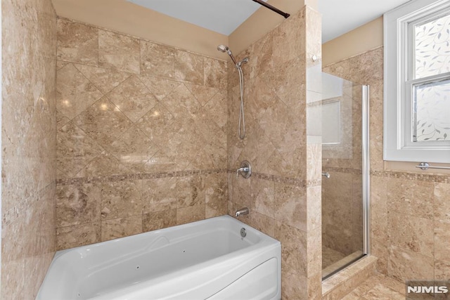 full bath with tile walls