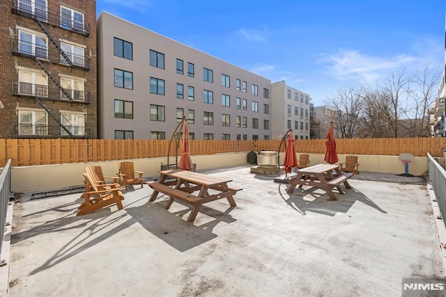 view of patio / terrace featuring an outdoor fire pit