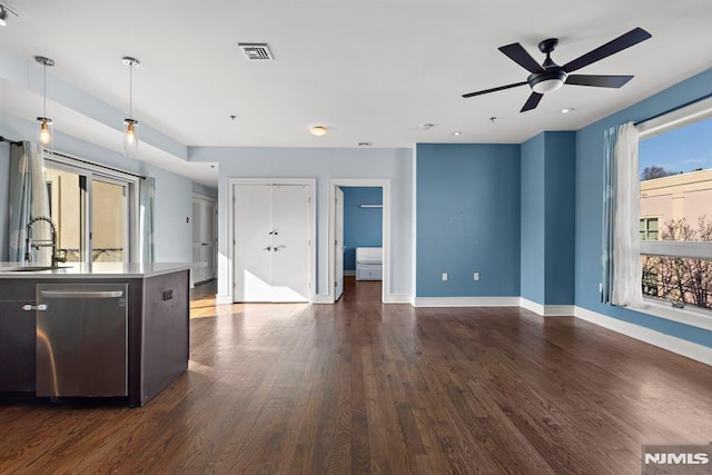 kitchen featuring dark hardwood / wood-style flooring, sink, dishwasher, and ceiling fan