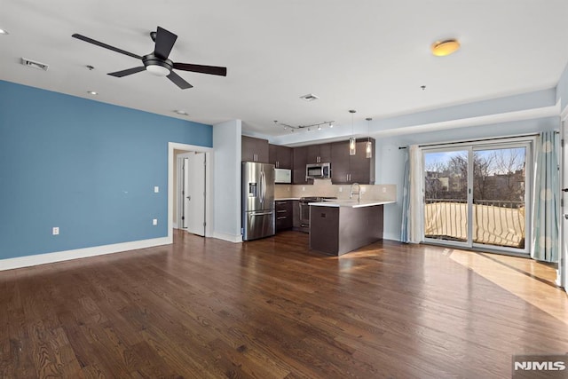 kitchen with dark brown cabinetry, visible vents, light countertops, appliances with stainless steel finishes, and decorative light fixtures