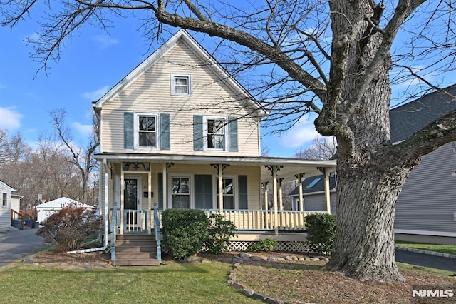 view of front facade with a front lawn and a porch