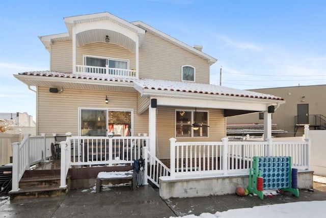 rear view of house featuring covered porch