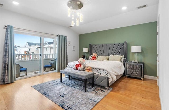 bedroom with access to exterior and wood-type flooring