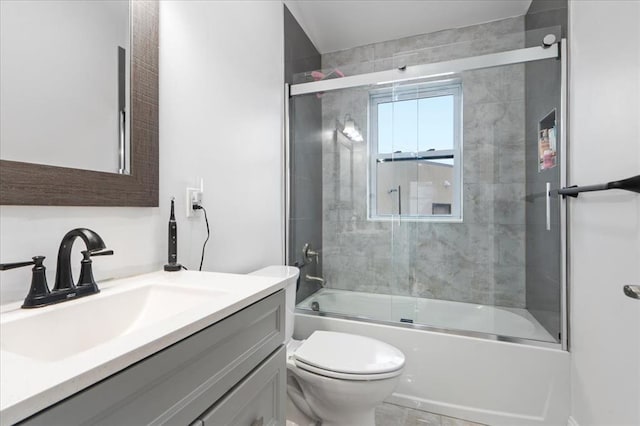 full bathroom with vanity, toilet, and combined bath / shower with glass door