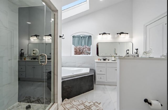 bathroom featuring vanity, independent shower and bath, and vaulted ceiling with skylight