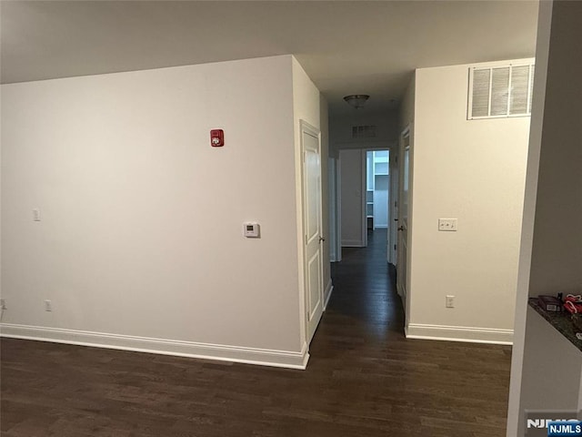 hallway with dark hardwood / wood-style floors