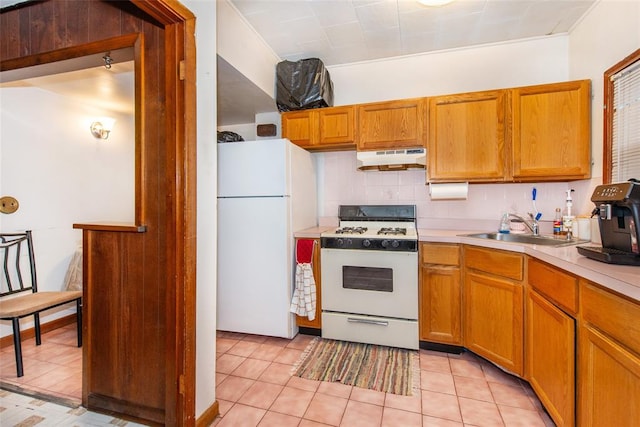 kitchen with light tile patterned floors, white appliances, backsplash, and sink