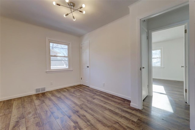 unfurnished room with hardwood / wood-style floors and plenty of natural light