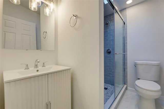 bathroom featuring tile patterned flooring, vanity, toilet, and a shower with shower door