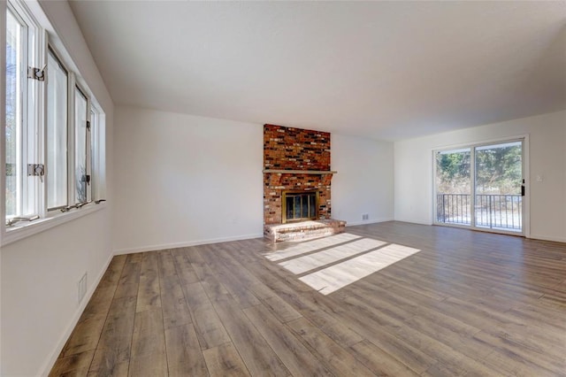 unfurnished living room featuring hardwood / wood-style flooring and a fireplace