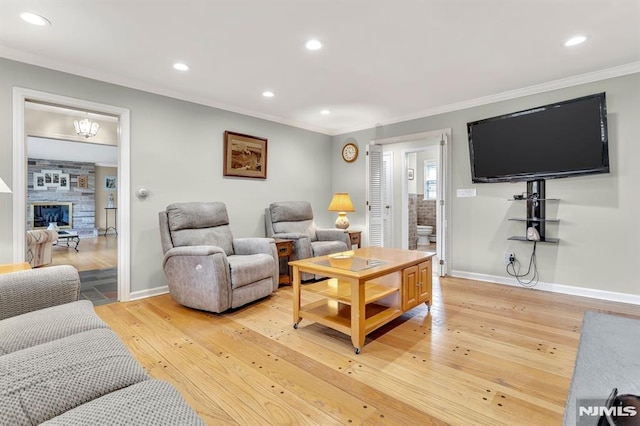 living room featuring light hardwood / wood-style flooring and crown molding