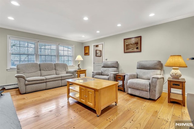 living room with light hardwood / wood-style floors, crown molding, and a baseboard heating unit