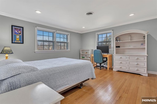 bedroom featuring light wood-type flooring, ornamental molding, and multiple windows