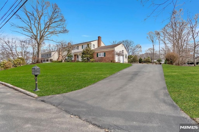 view of front of property with a front yard and a garage