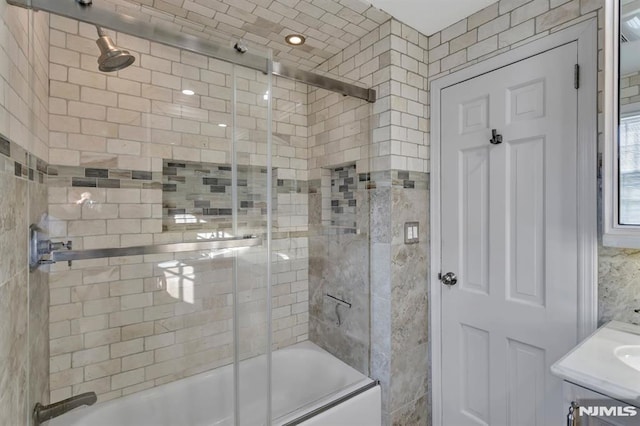 bathroom featuring vanity and enclosed tub / shower combo