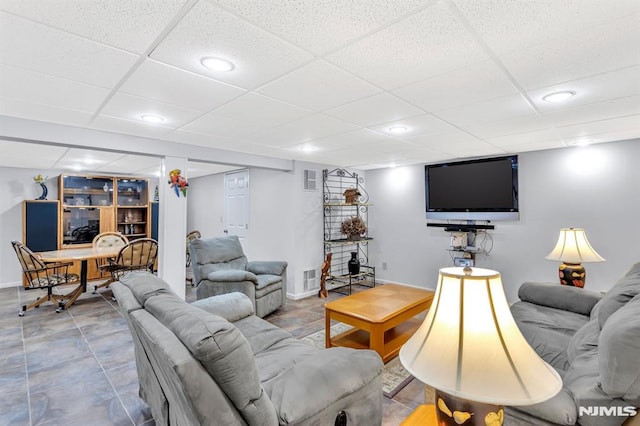 living room with a drop ceiling